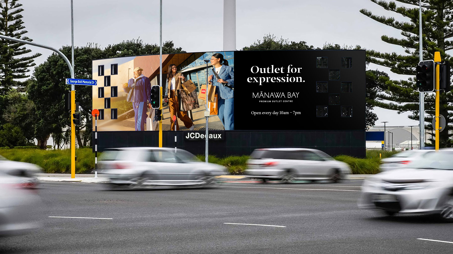 Photo of a giant Mānawa Bay billboard near Auckland Airport, featuring campaign artwork created by Difference