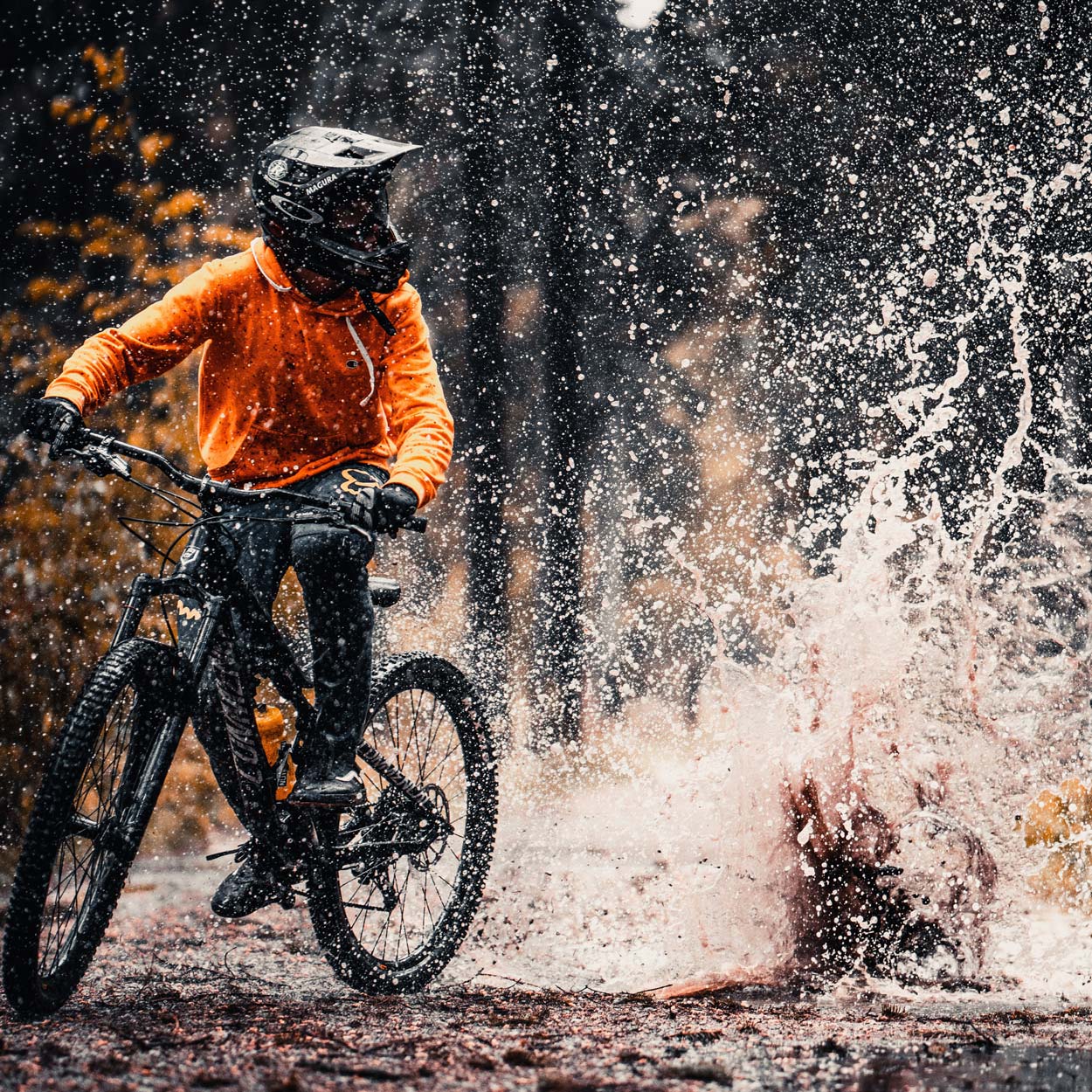 Photo of a mountain biker riding through a puddle
