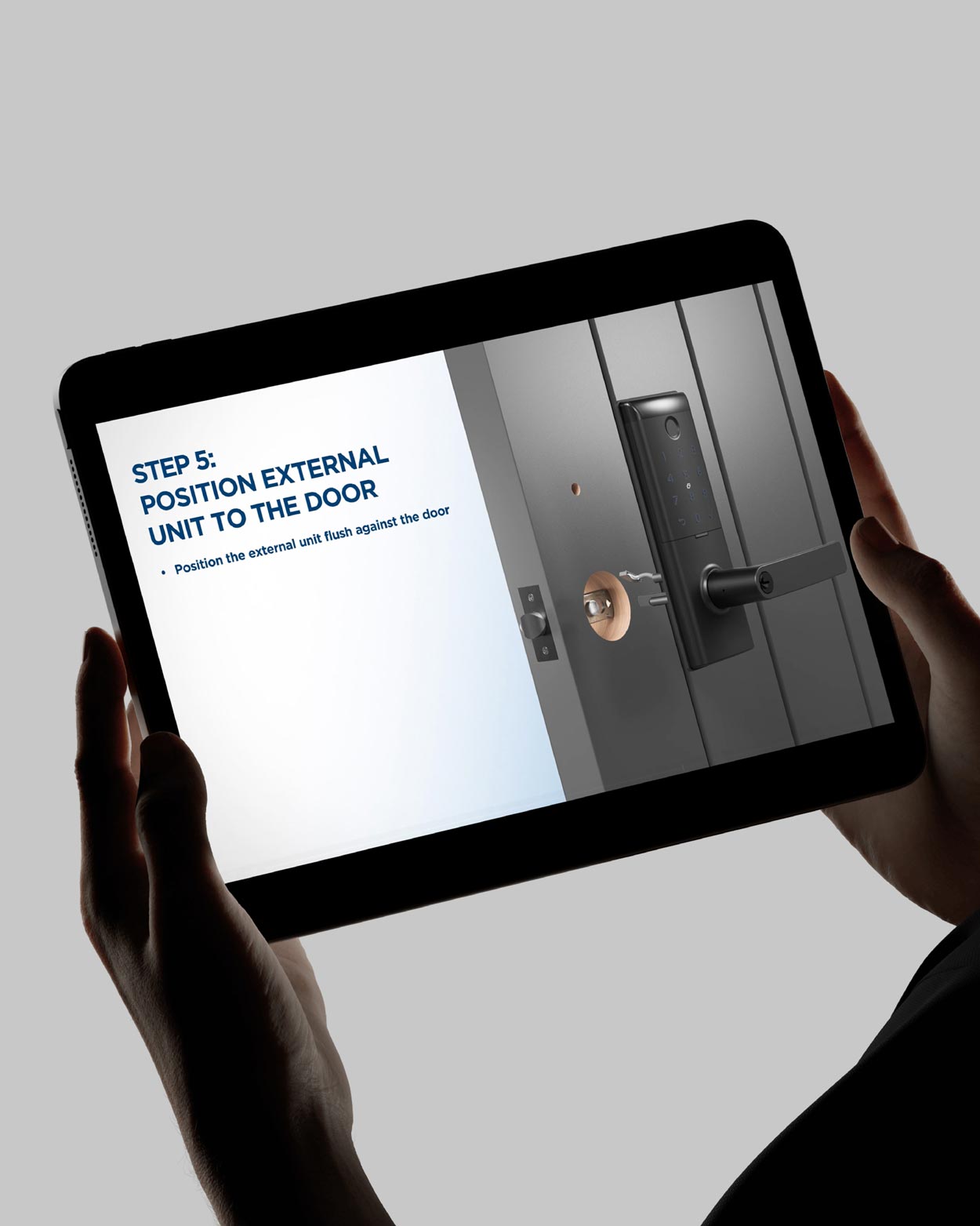 Photo of someone holding an iPad, viewing a Schlage installation manual